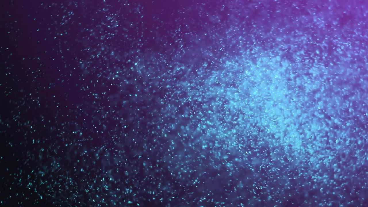 animación de puntos brillantes de luz que se mueven sobre un fondo oscuro