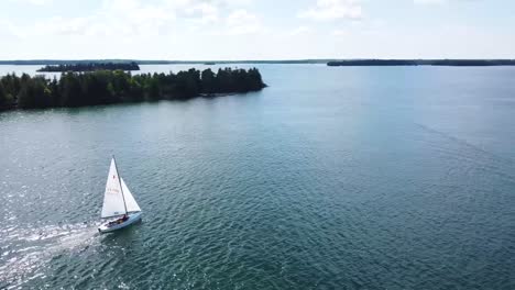 following aerial of sailboat in summer sun - hessel, michigan - lake huron