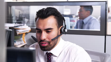 Young-Hispanic-man-working-in-a-customer-service-call-centre