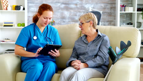 female doctor holding tablet computer in nursing home