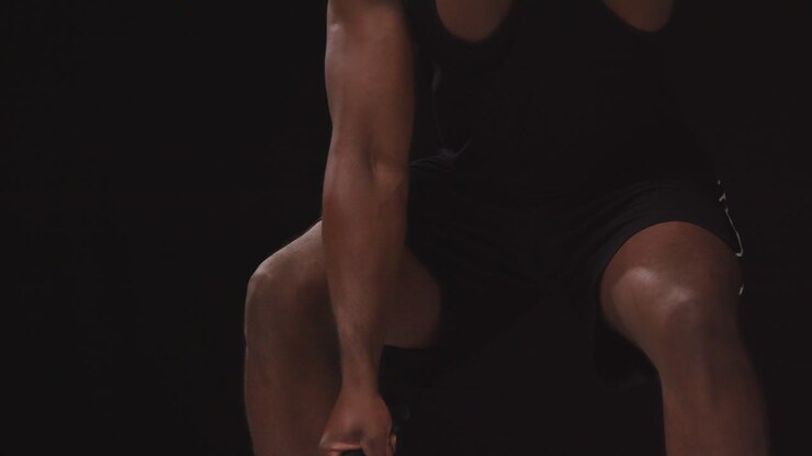 Close Up Studio Shot Of Male Athlete Training In Fitness Vest Using Battle Ropes Shot Against Black Background 1