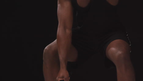 Close-Up-Studio-Shot-Of-Male-Athlete-Training-In-Fitness-Vest-Using-Battle-Ropes-Shot-Against-Black-Background-1