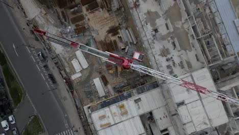 construction site at porte de la chapelle in paris, crane, unfinished structures, and urban development, france. aerial top-down ascending