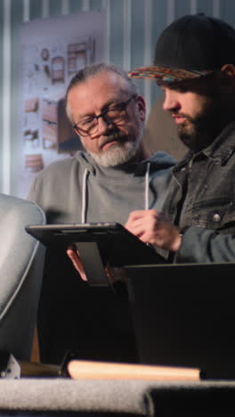 two men collaborating on a design project using a tablet