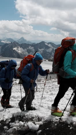 hikers on a snowy mountain summit