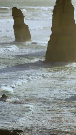 a serene view of the twelve apostles rock formations along the great ocean road, captured at sunrise with gentle waves