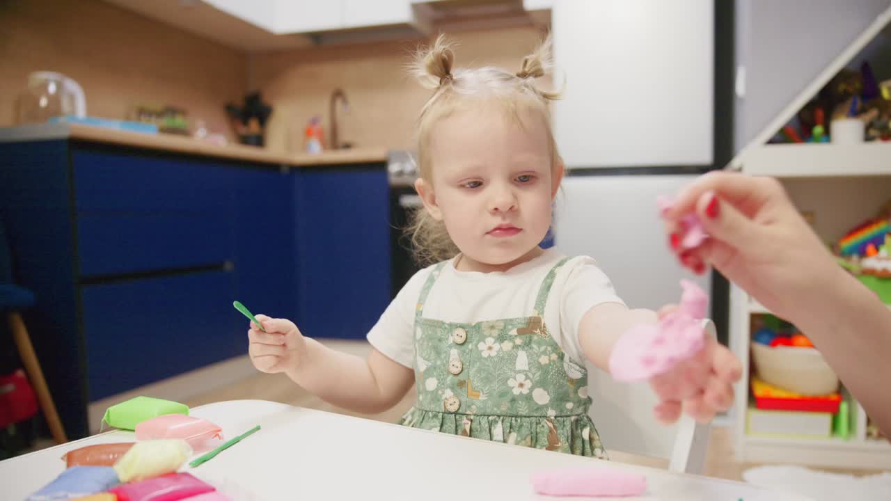 Cute Toddler Girl Playing with Colorful Playdough at Home