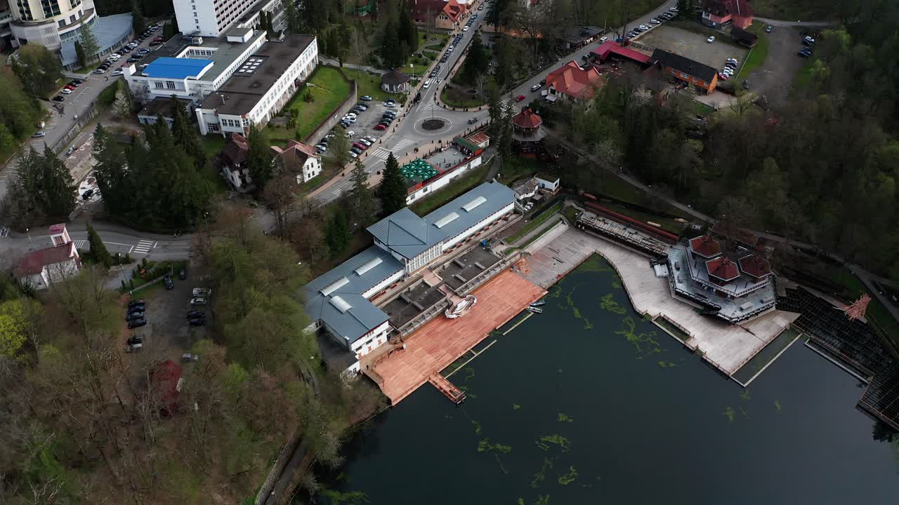 Lacul Ursu and Sovata hotel on shore, Romania. Aerial top-down reverse