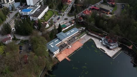 lacul ursu and sovata hotel on shore, romania. aerial top-down reverse