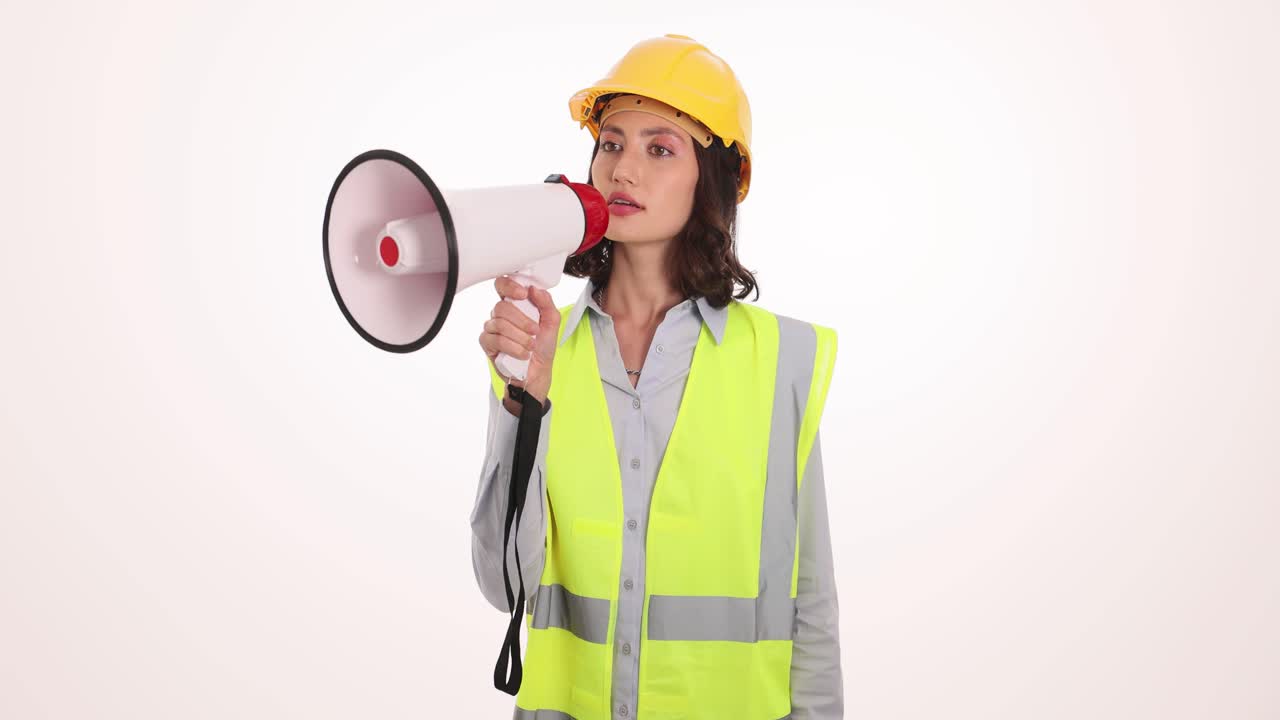Woman in Hard Hat and Safety Vest Holding a Megaphone