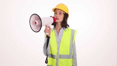 woman in hard hat and safety vest holding a megaphone