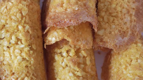 close-up shot of crunchy almond tejas cookies, highlighting their texture and golden hue under soft lighting