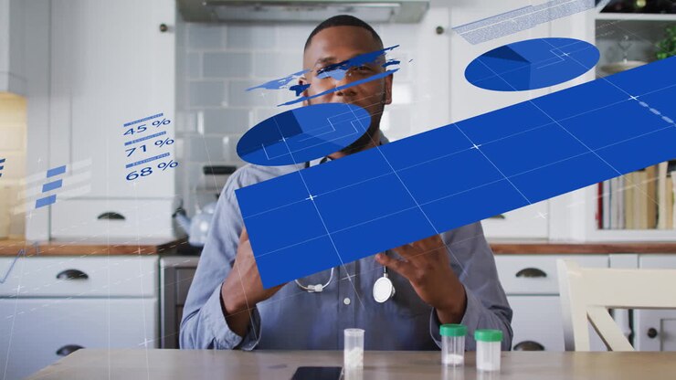 At kitchen table, man with animation of graphs and charts, smiling