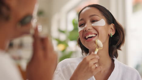 woman using face roller and eye patches in mirror