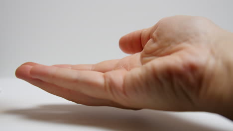 addict pours out pills into their hand