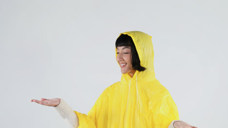 Woman-in-yellow-raincoat-gesturing-to-feel-the-rain-4K-4k