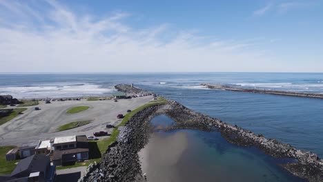 aerial descending shot swoops towards river mouth as tide comes in, bandon oregon