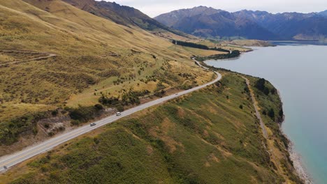 scenic road trip along a turquoise lake in new zealand