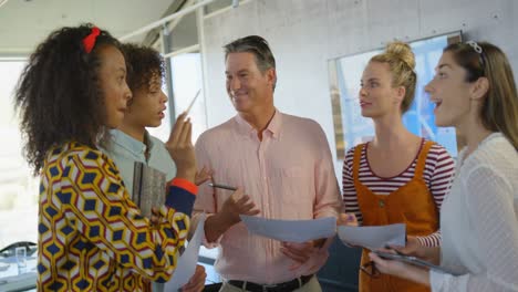 Front-view-of-mixed-race-business-executives-interacting--together-in-modern-office-4k