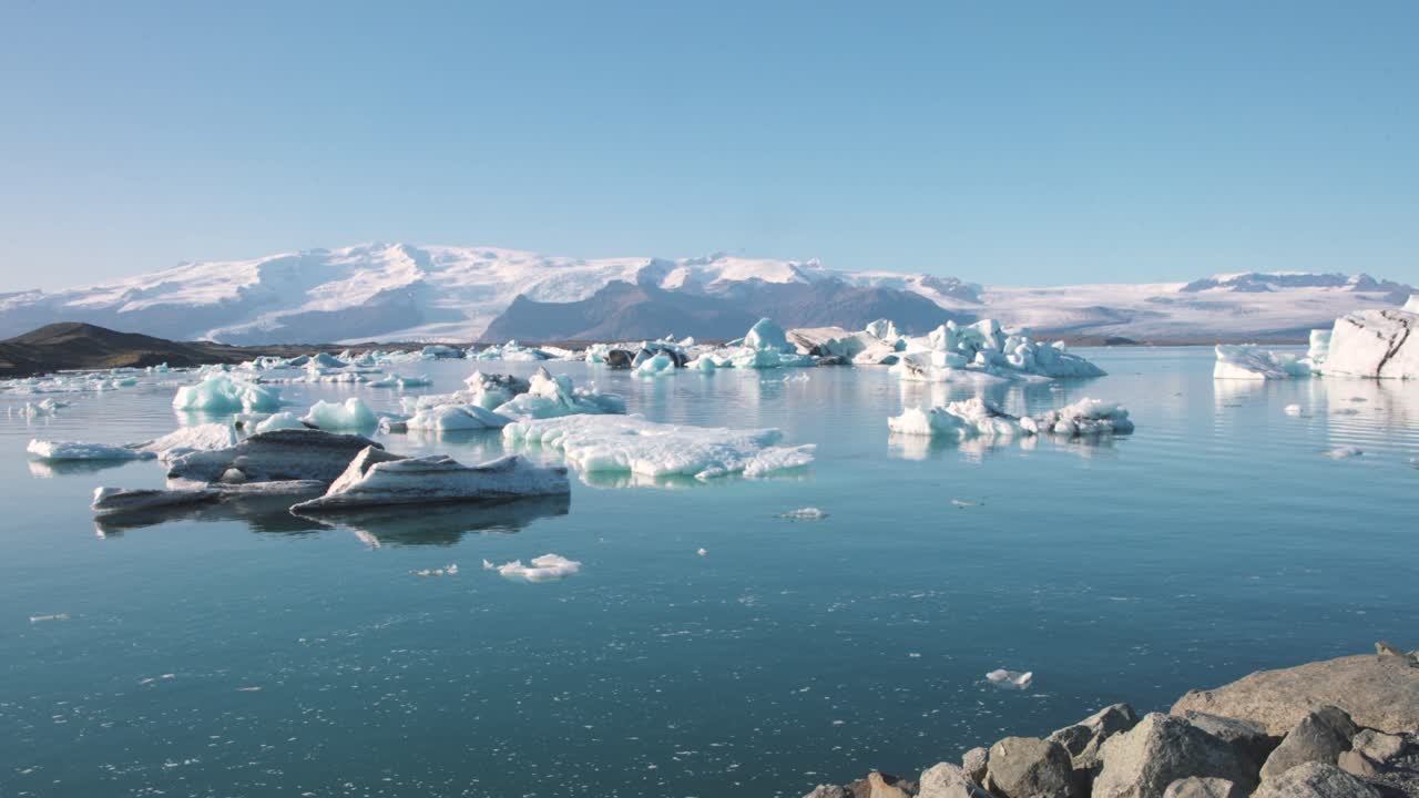 Arctic panorama of ice cold sea lagoon with icebergs and mountains