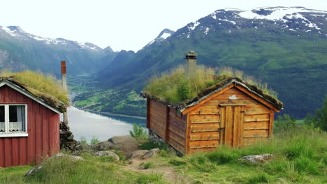 sod roof cabins in rakssetra with mountains and fjord view in loen, norway