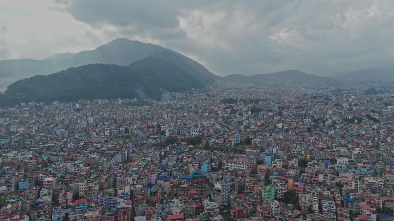 Aerial drone footage of Kathmandu Valley in Nepal, featuring sprawling cityscape, surrounding green hills, and the unique blend of urban and natural landscapes from above
