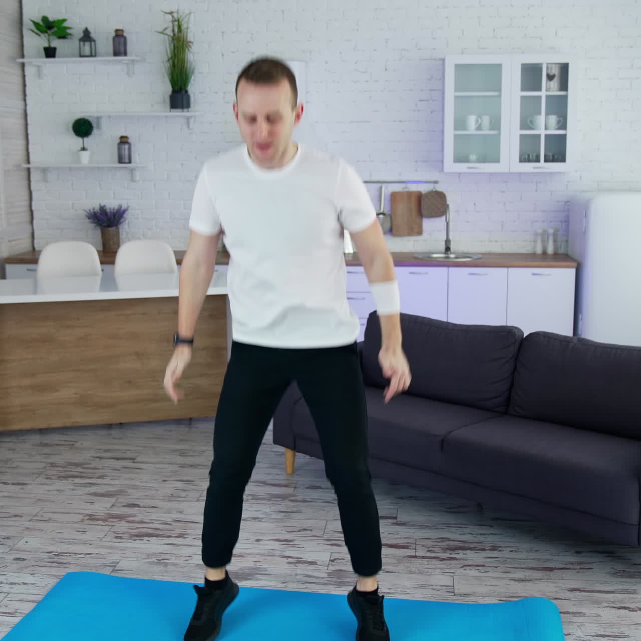 Quarantine man doing exercise indoor. Lifestyle strong man training his body in home