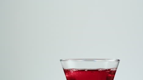 pouring red liquid into a glass