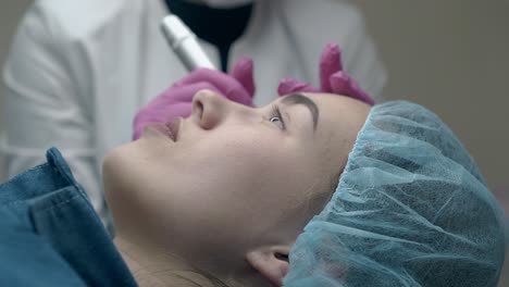 beauty salon specialist applies makeup on young woman face