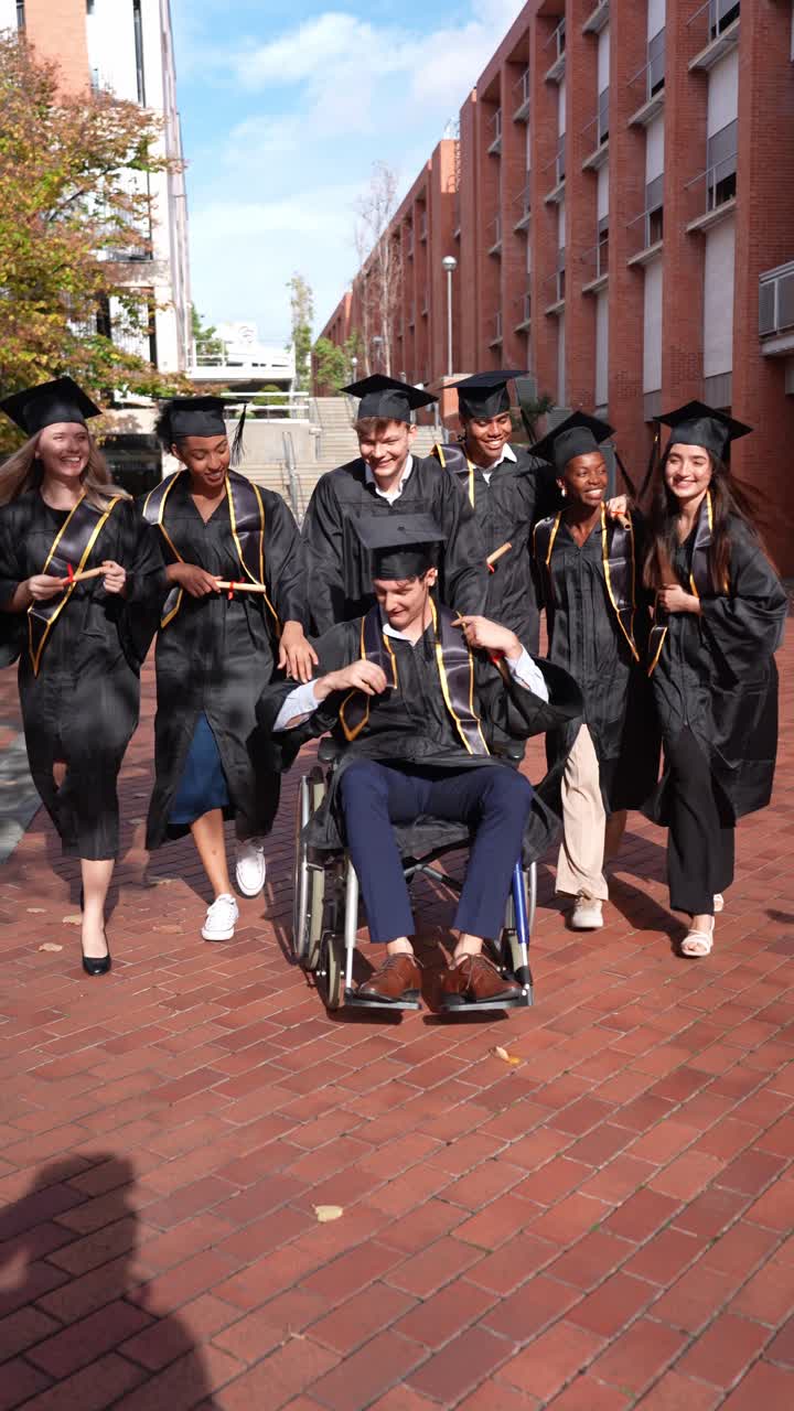 Diverse Group of Graduates Celebrating on University Campus with Friend in Wheelchair