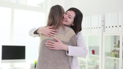 doctor and patient share a warm hug in a clinic setting