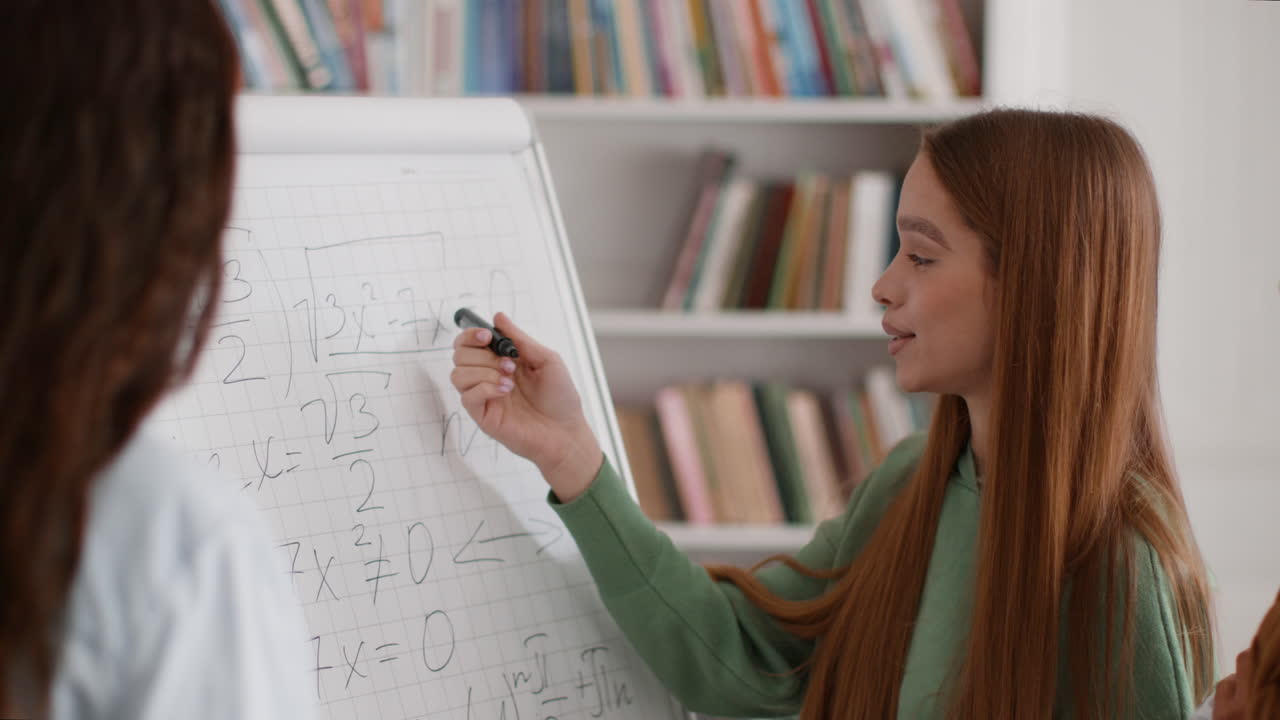 Students Solving Math Problems on Whiteboard