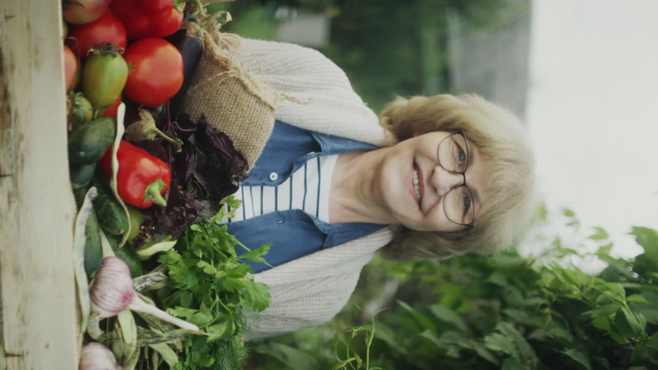 Happy Senior Woman with Freshly Harvested Vegetables