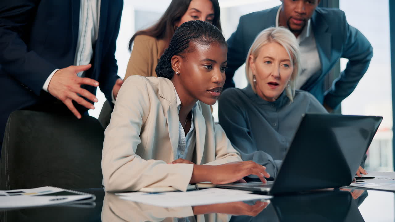 Business Team Meeting and Discussing Project on Laptop