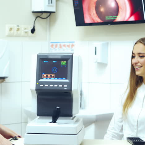 ophthalmology technology. woman doctor working with a patient using refractometer machine. modern device for testing eye vision.