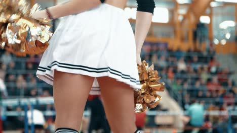 Closeup-of-cheerleader-girl's-legs-seen-from-under-white-skirt-during-dancing