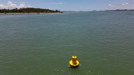 overhead aerial clip dollies around yellow buoy in remote northern australia