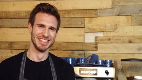 Portrait-of-smiling-waiter-standing-with-arms-crossed-4k