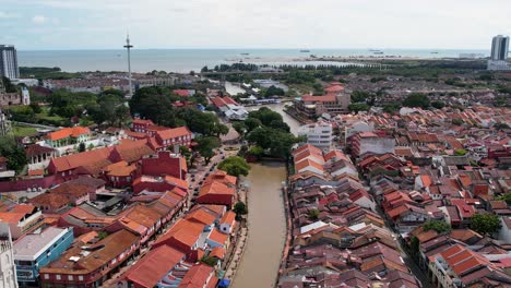 drone moves back and captures the malacca river and the city of malacca in malaysia