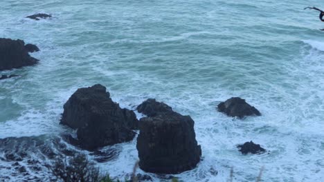 waves hitting rocks which jut out from the sea