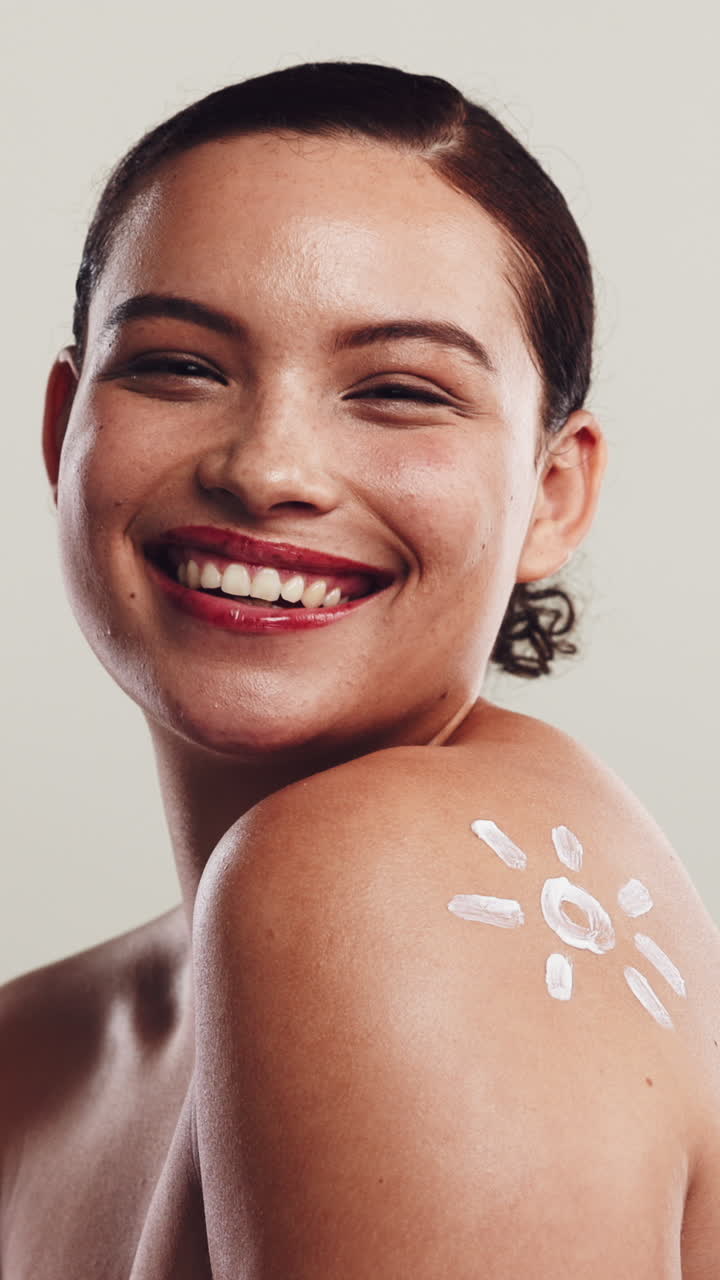 Happy Young Woman with Sunscreen Sun Design on Shoulder