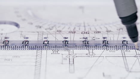 close-up of an architectural blueprint with a ruler and drawing tool