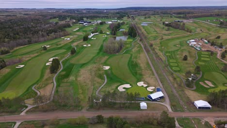 aerial: establishing drone shot of tpc toronto at osprey valley golf course during the day in alton, caledon, ontario, canada