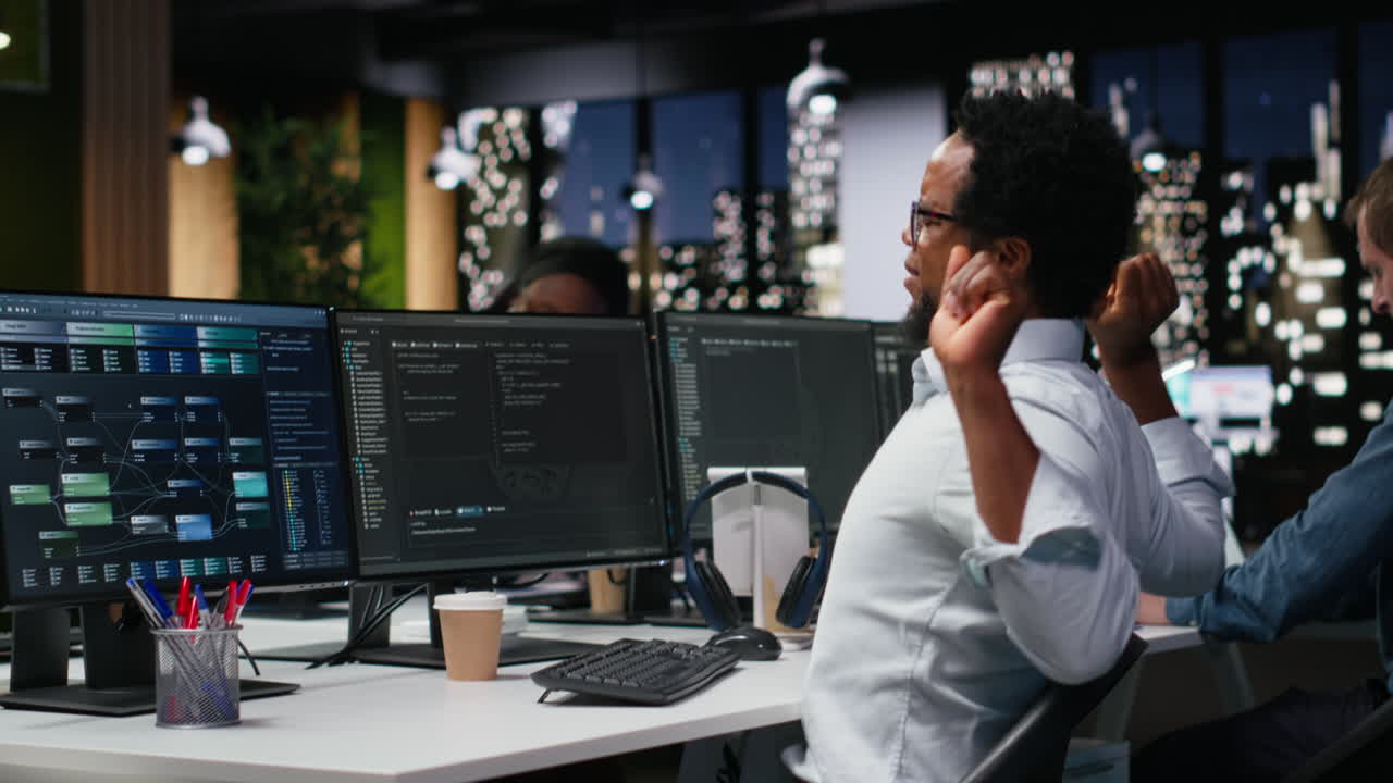 African American Software Developer Working Late on Computers
