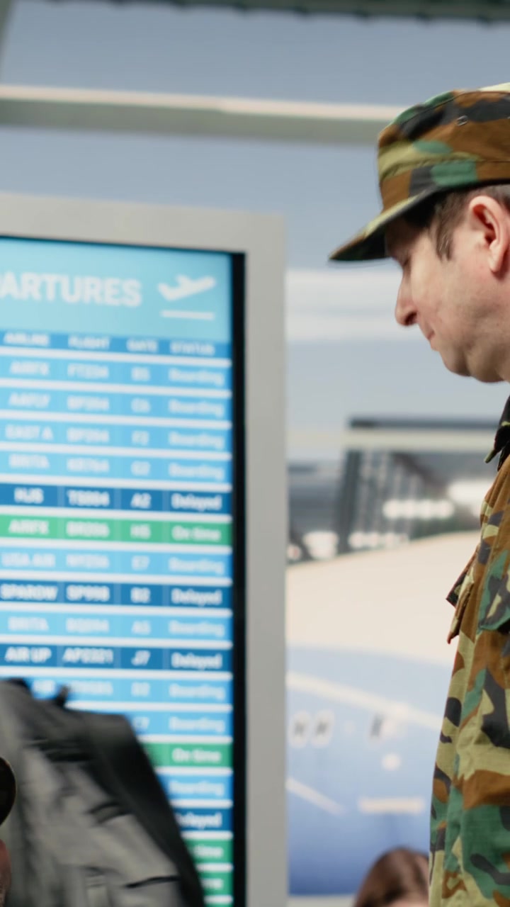 Vertical video Military team troops in airport lounge talking while waiting for plane departure