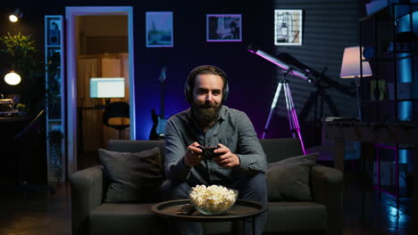 cheerful gamer wearing headphones, chatting with teammates while gaming