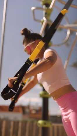 woman doing trx outdoor workout