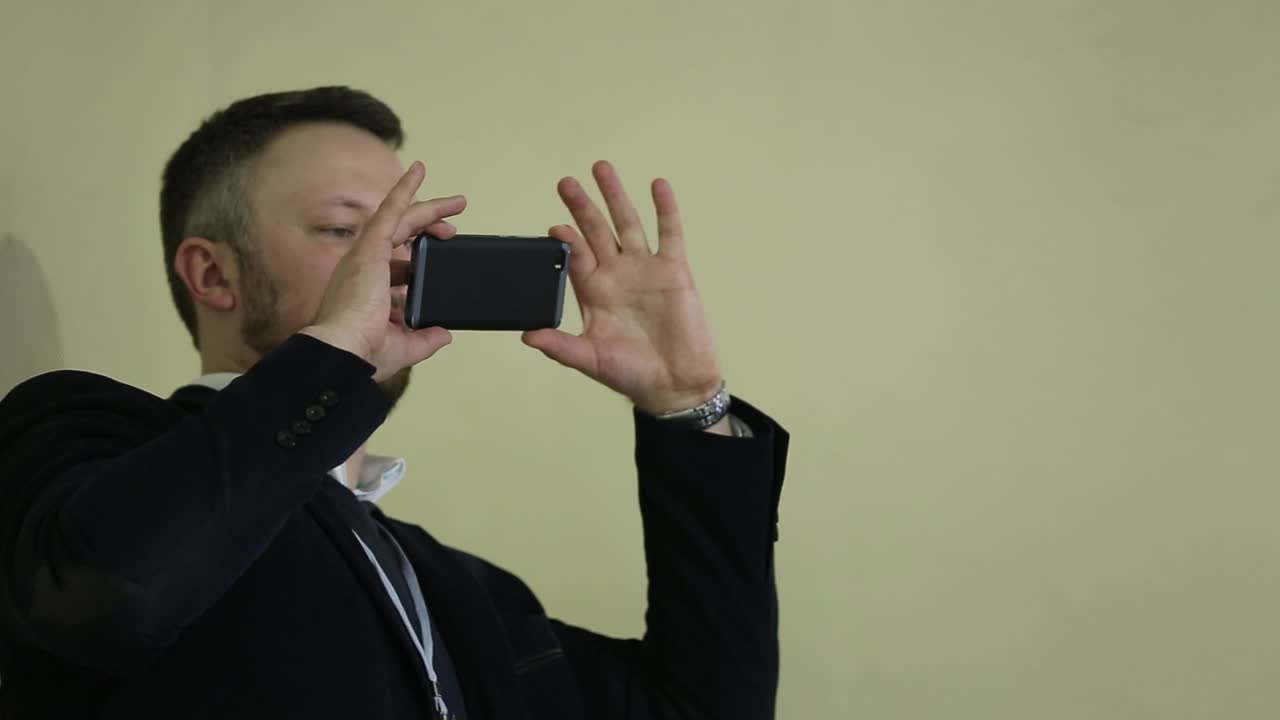 Man Taking Photo At Conference Room. Man holding phone and taking photo at conference room meeting
