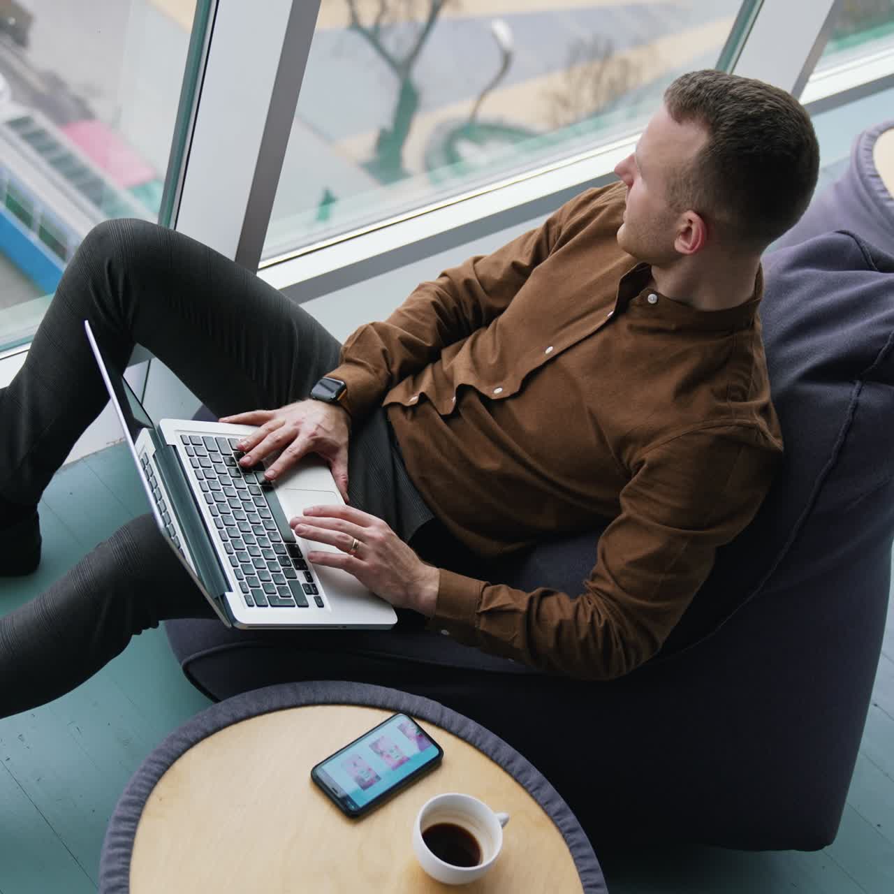 Attractive man using laptop in co-working space