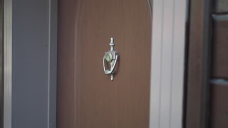 wooden door with doorbell and peephole